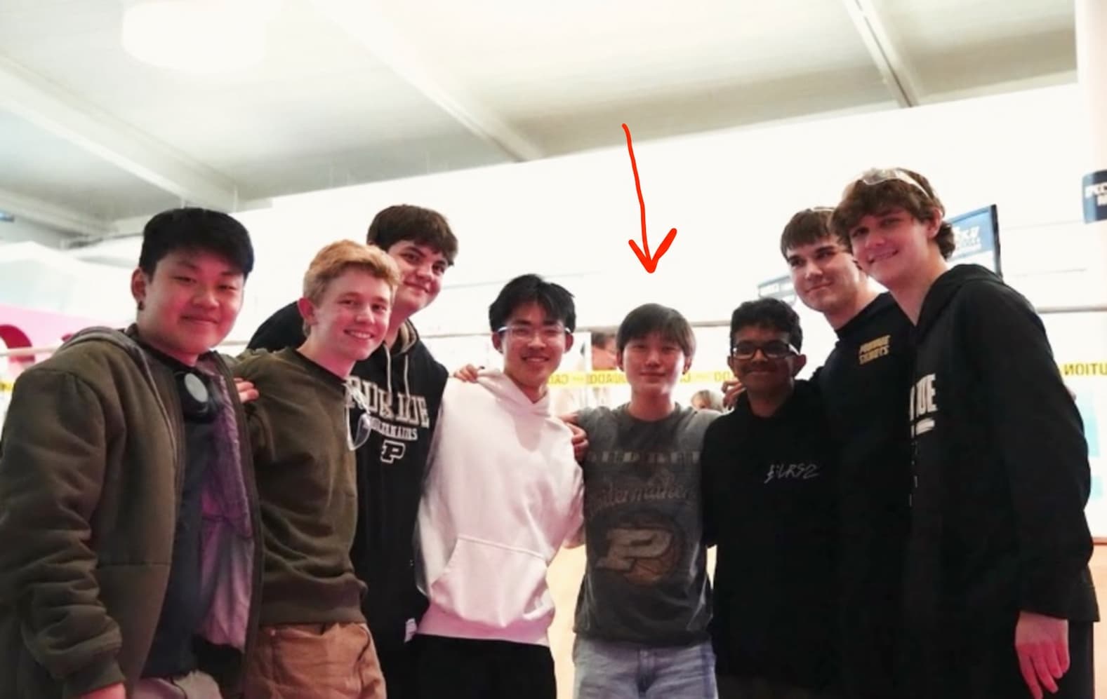 Nathan, indicated by a red arrow, with friends and teammates